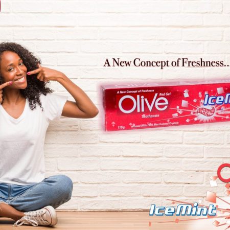 Young black woman sitting on a wooden floor smiles, pointing mouth, concept of perfect teeth, white teeth, has a cheerful and jovial attitude